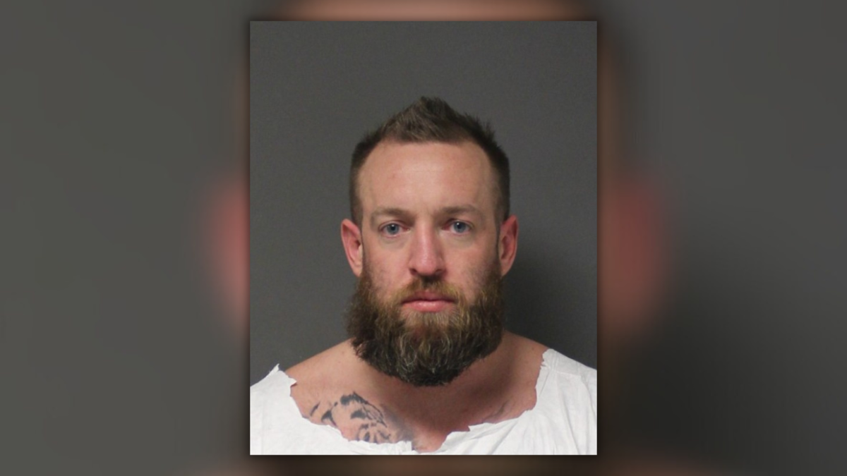 Zachary Apt looks into the camera for his mugshot