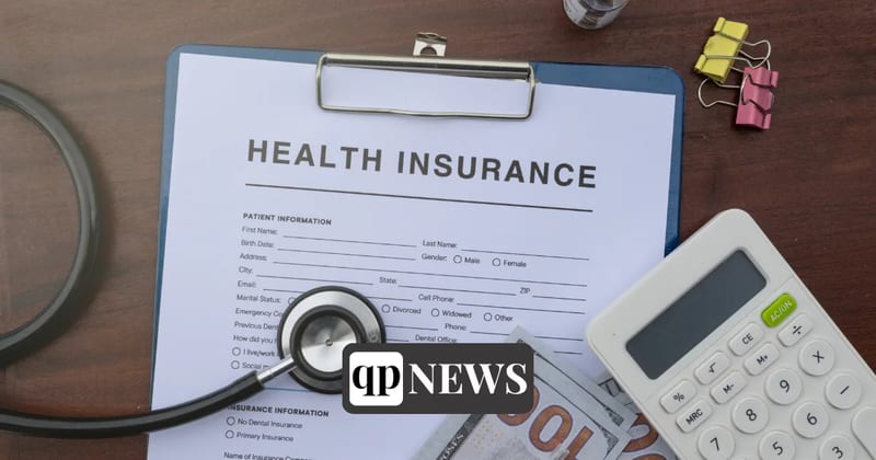 A health insurance form on a clipboard with a stethoscope and a calculator