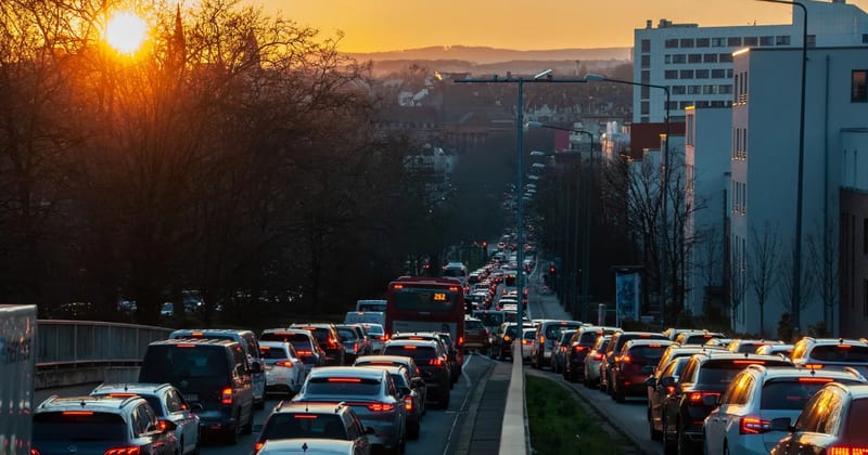 Traffic on a multi-lane road at sunset
