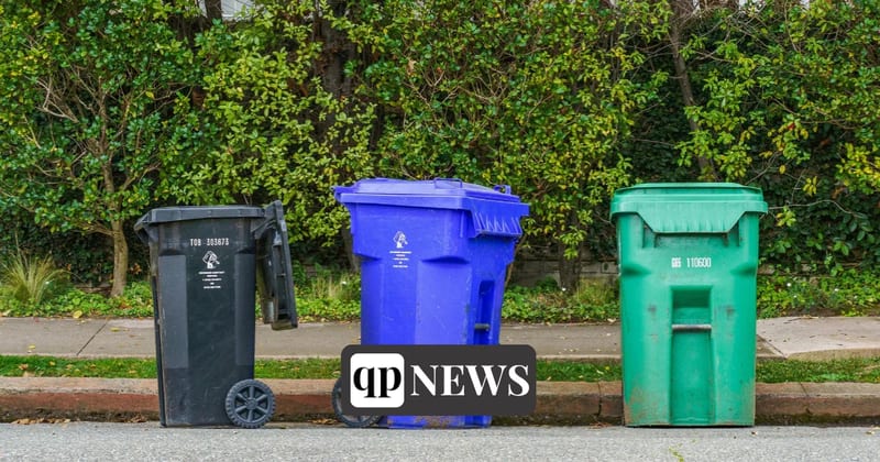 Trash, recycling and yard-waste bins at a curb
