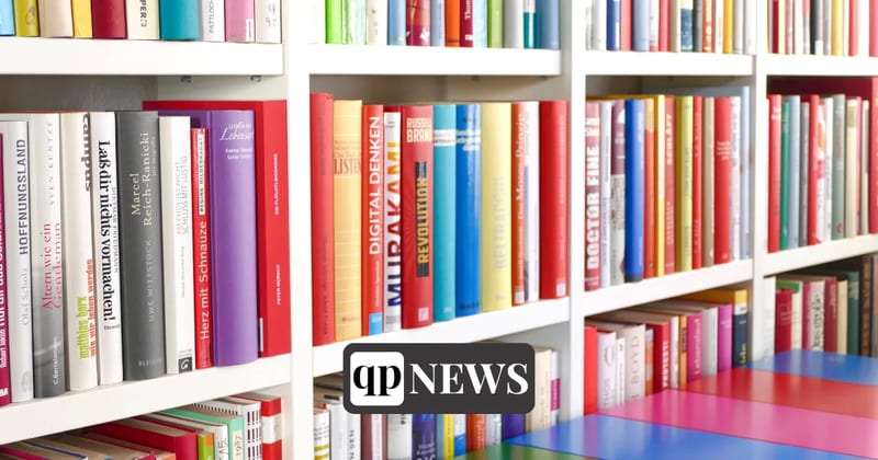 Colorful books on white library shelves