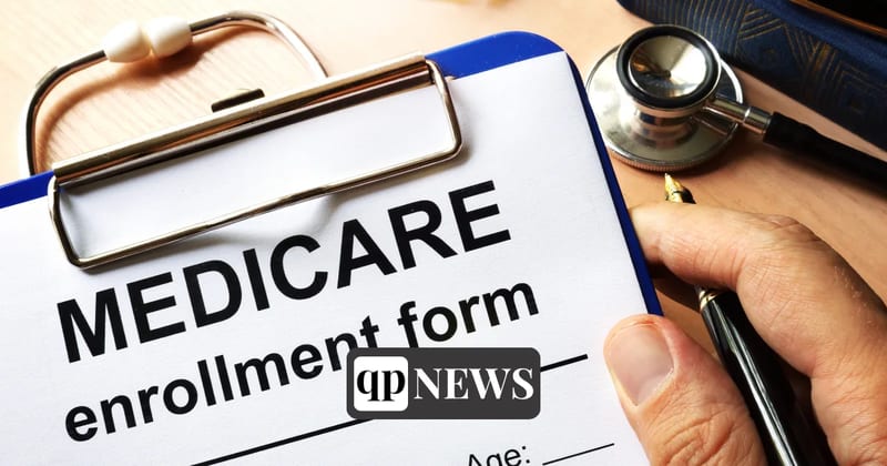 A Medicare enrollment form on a clipboard beside a stethoscope and a pen
